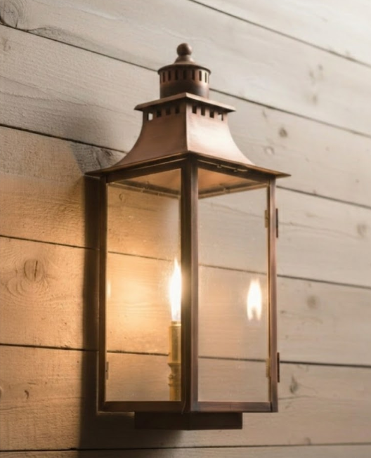 Decorative outdoor wall light fixture on a wooden wall