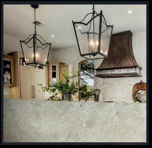 Kitchen with hanging foyer entryway kitchen island pendant light or chandelier and a rustic vent hood.