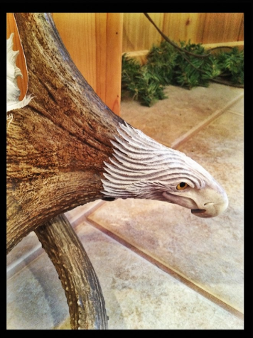 The eagle head carved into a moose antler base.