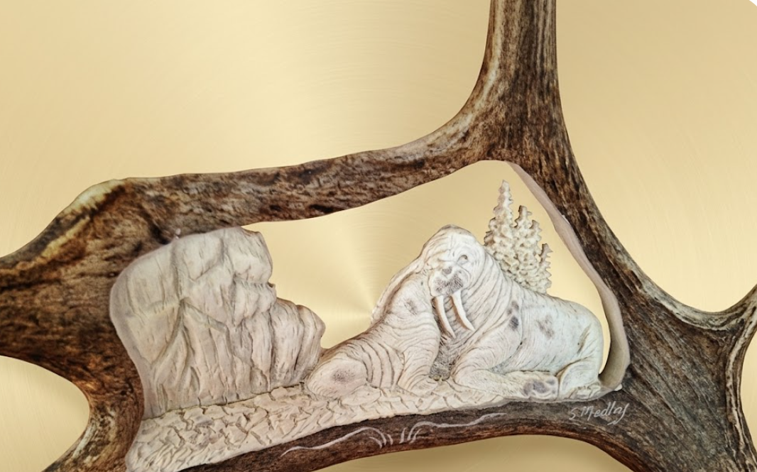 Carved antler with an icecap and bushes setting featuring walrus momma and baby with beige background