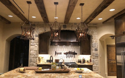 Modern kitchen with stone walls, granite countertops, and foyer or entryway kitchen island pendant light or chandeliers.