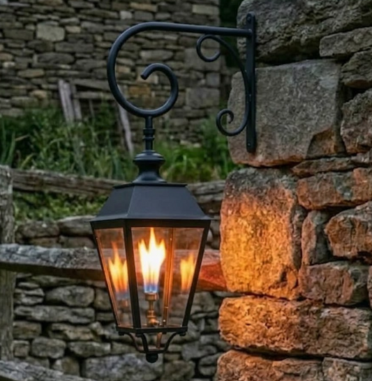 Decorative outdoor lamp hanging on a stone wall