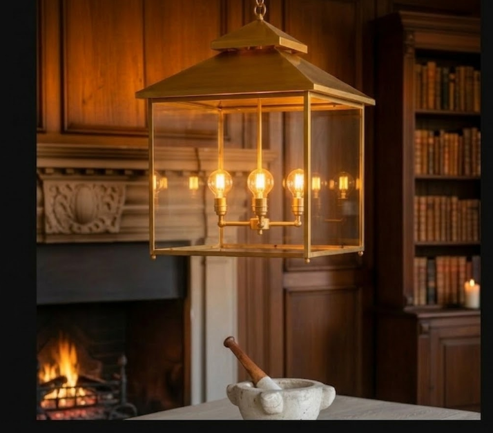 Decorative hanging light fixture in a warm, wooden interior setting with a fireplace and bookshelf.