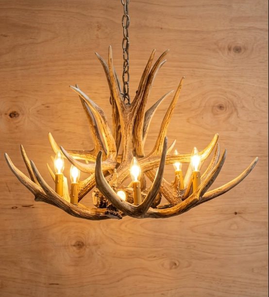 faux deer Antler chandelier with lights on a wooden background