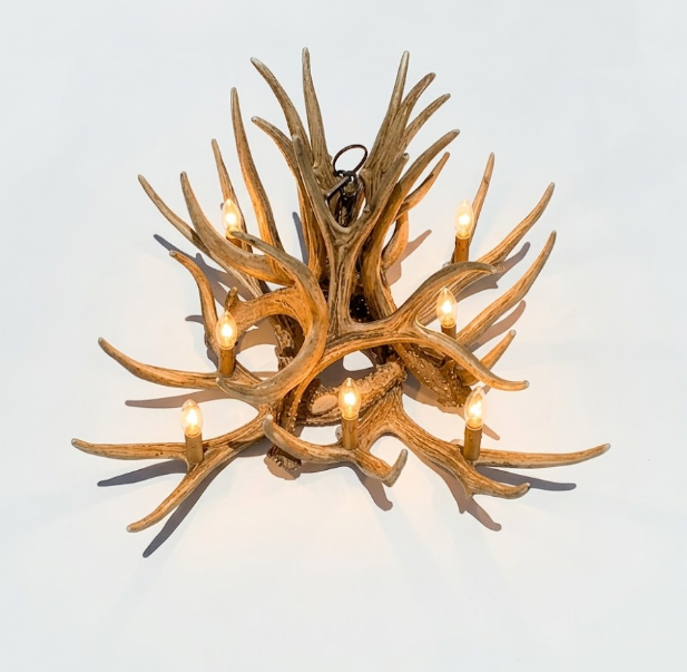 faux deer Antler chandelier with multiple lights on a light gray background