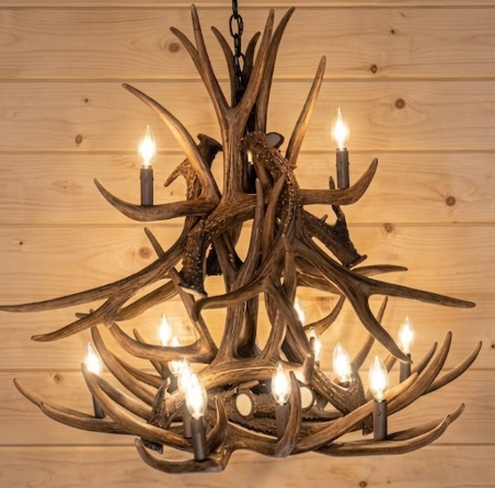 faux deer Antler chandelier with multiple lights on a wooden background