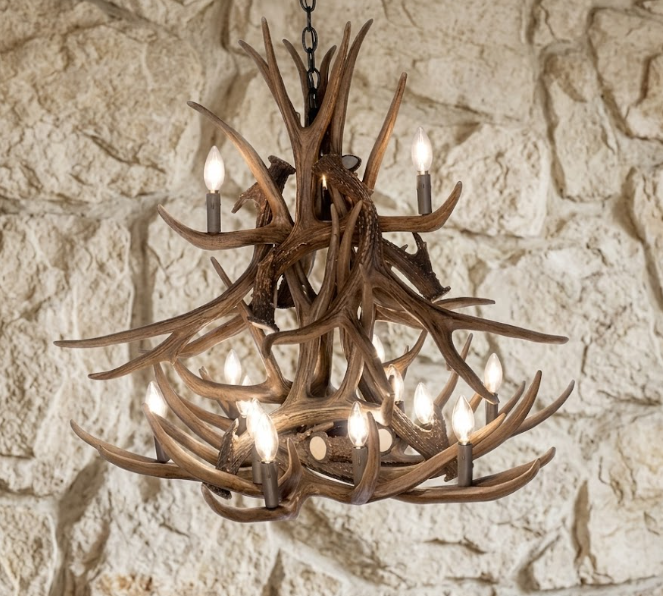 faux deer Antler chandelier against a stone wall background