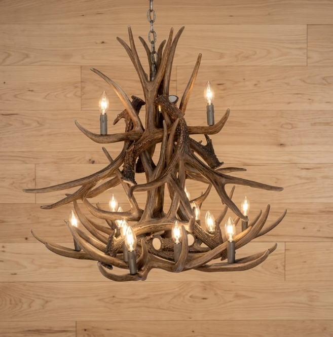 faux deer Antler chandelier with multiple lights on a wooden wall background