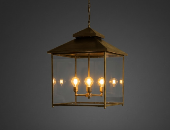 Decorative hanging Kitchen Island Pendant Light Fixture lantern with multiple light bulbs on a dark background in a kitchen area