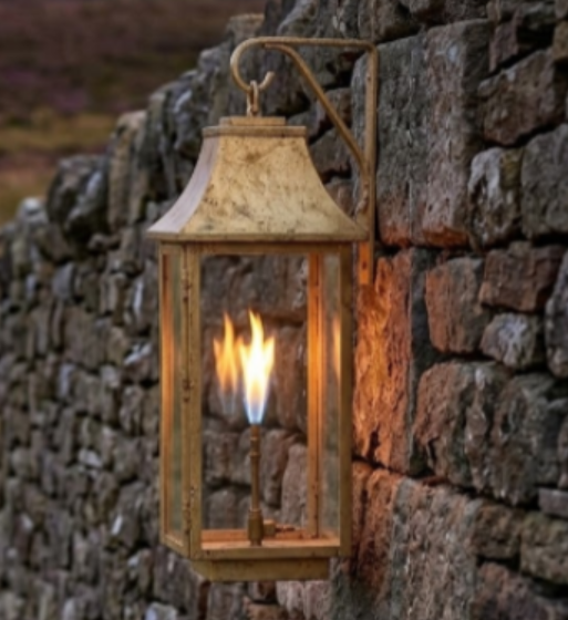 Decorative lantern with flames attached to a stone wall