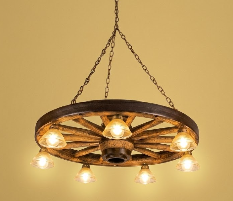 Wooden Rustic faux wagon wheel wagon wheel chandelier with multiple light bulbs on a yellow background