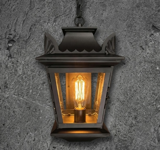 Decorative outdoor lantern with a lit bulb on a textured wall background
