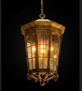 Decorative hanging foyer entryway pendant light with glass panels on a black background