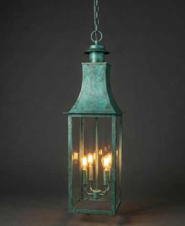 Bronze hanging kitchen island pendant lantern with three illuminated lights against a dark background