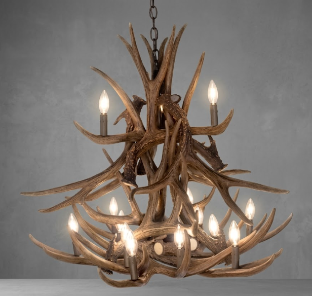 faux deerAntler chandelier with multiple lights on a gray background
