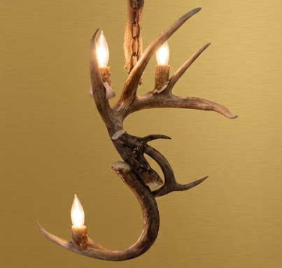 deer Antler wall sconce chandelier with three lights on a gold background