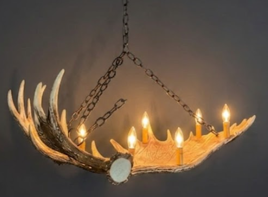 Faux moose Antler chandelier with candles on a dark background