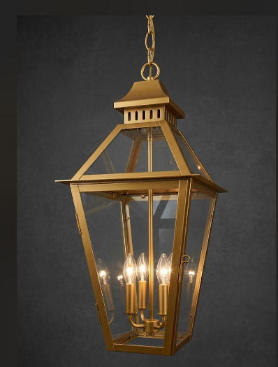 Gold lantern with four light bulbs on a dark background