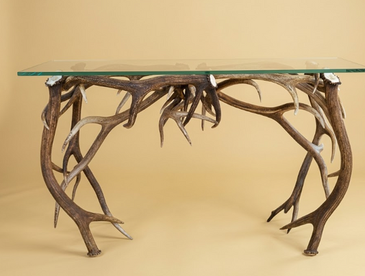 Glass-top sofa/console table table with antler design on a beige background