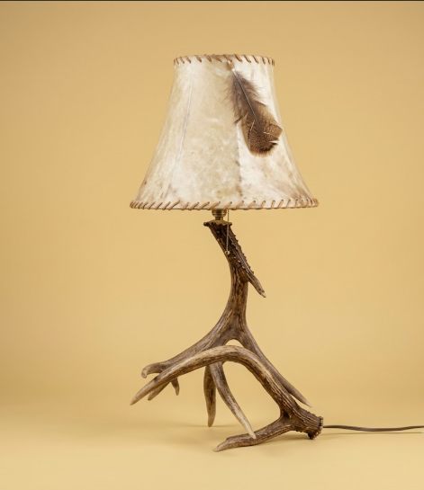 Table lamp with natural wood base and textured beige shade on a beige background