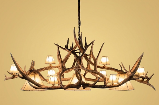 Antler chandelier with multiple lights on a beige background