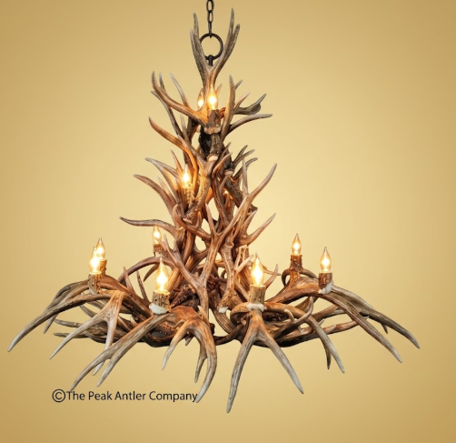 Deer Antler chandelier with multiple lights on a beige background, branded 'The Peak Antler Company'.