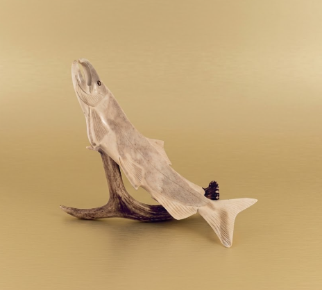 Wooden fish sculpture on a beige background