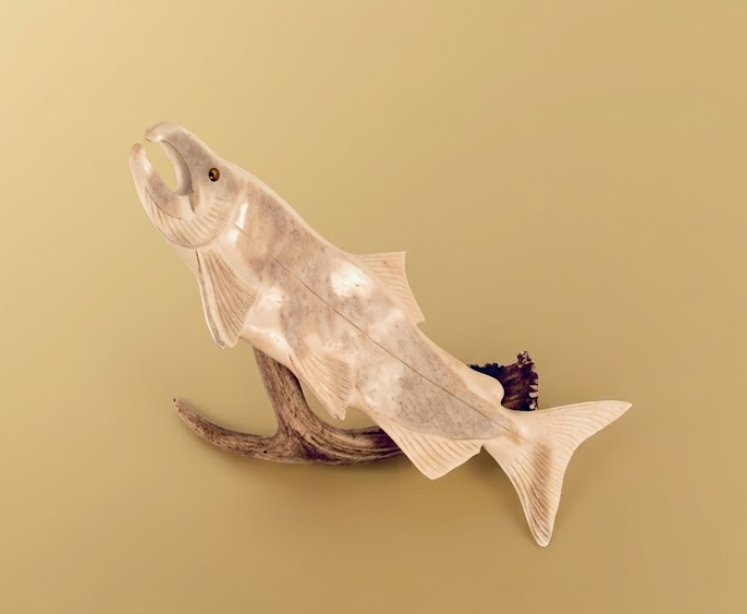 Decorative fish sculpture on a beige background