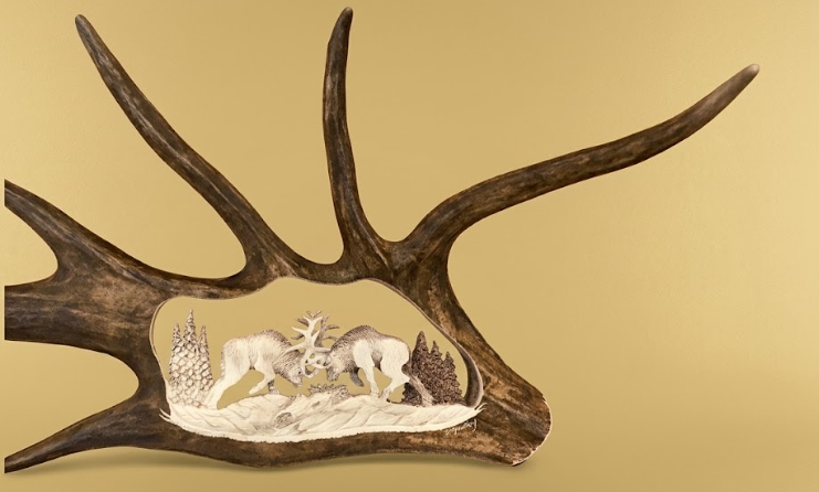 Decorative wall art with deer antlers and carvings on a beige background