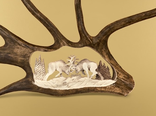 Decorative antler with carvings of deer in a forest on a beige background