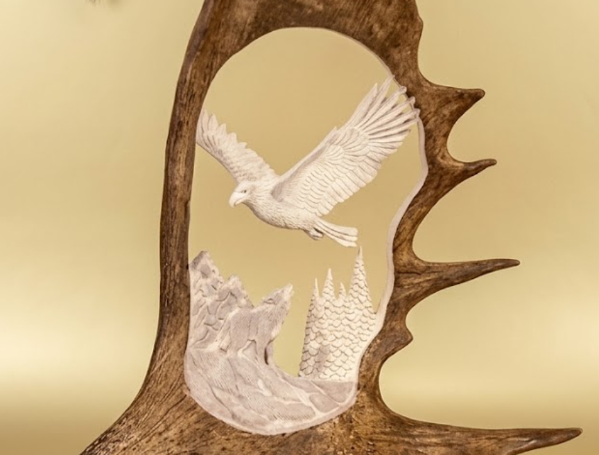 decorative wall hanging of a soaring eagle and the wolves howling at it.