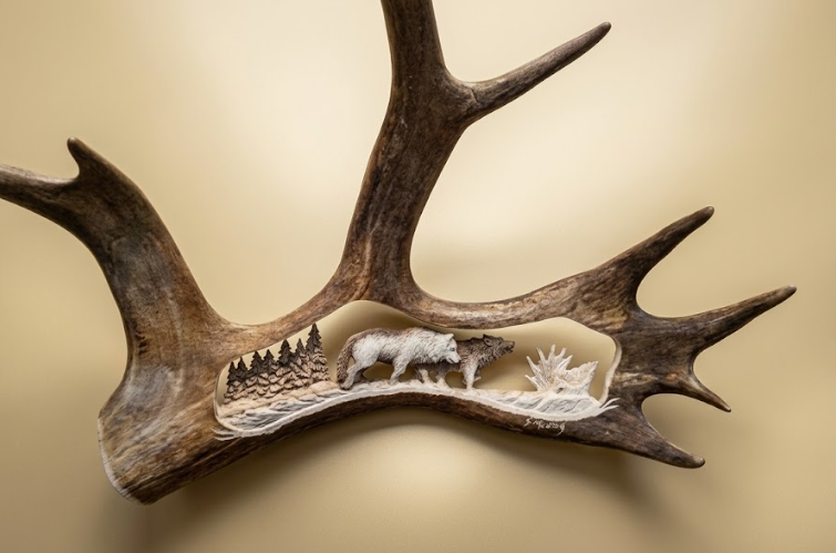 Beautiful carving of two wolves on the hunt in the forest. On a tan background.