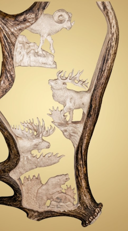 Decorative wall art with moose antler carved-out animal silhouettes on a beige background