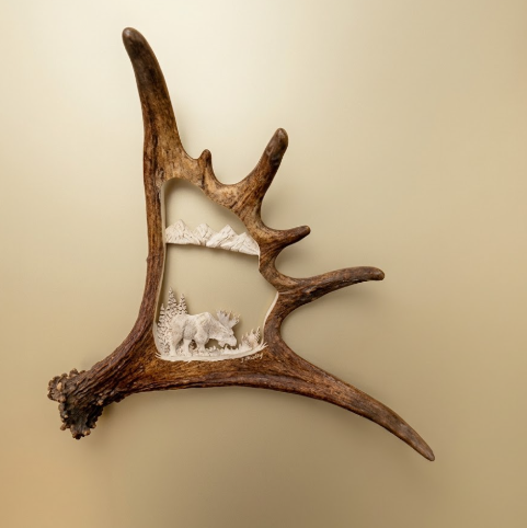 Decorative wall art on a  caribou antler caribou a snowy landscape scene of a grazing Alaskan
moose on a beige background