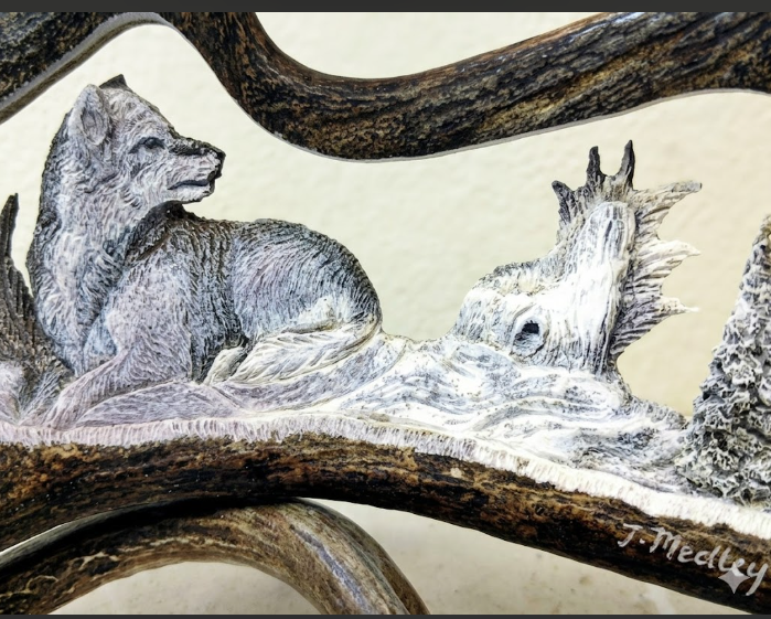 Desk mount carving of napping wolf watching out over the horizon. on a cream background. 