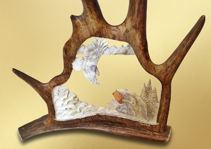 Decorative piece with antlers and natural elements on a beige background