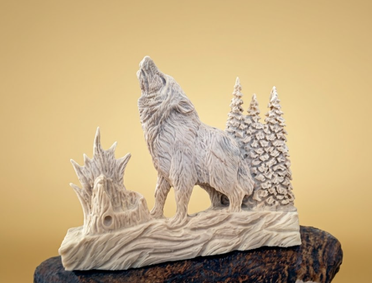 Wolf sculpture on a natural antler base with trees against a gold background
