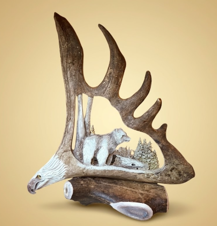 Magnificent hand carved moose antler with eagles head and big bear in the mountains