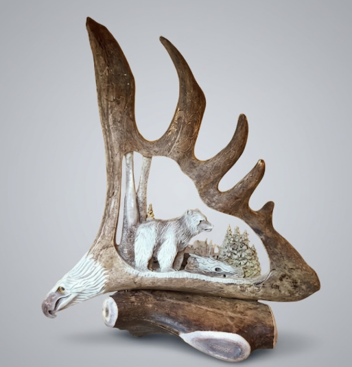 Big bear moose antler carving with magnificent eagles head, desk mount on a white background.