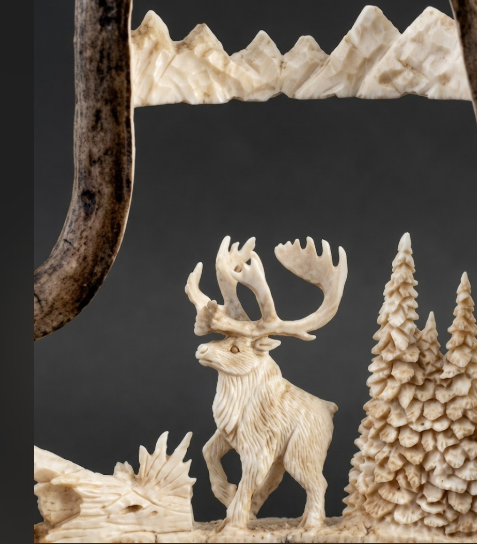 caribou antler carving from a moose antler on a grey background.
