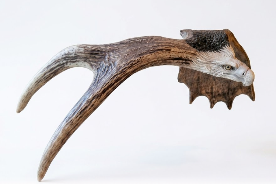 Decorative antler with an eagle's head on a white background