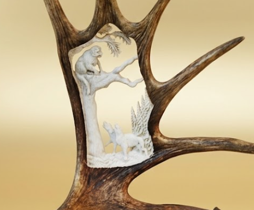 mountain lion moose antler carving with two hunting dogs 