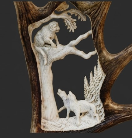 Mountain lion treed by the dogs carving from an antler 