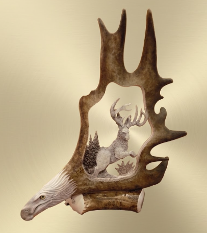 Decorative wall art with an eagles head head and jackalope carved into the caribou antler on a beige background 