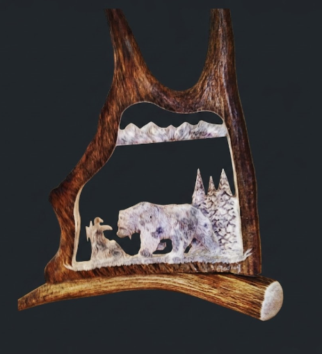 Hungry bear moose antler carving in a mountain scene.