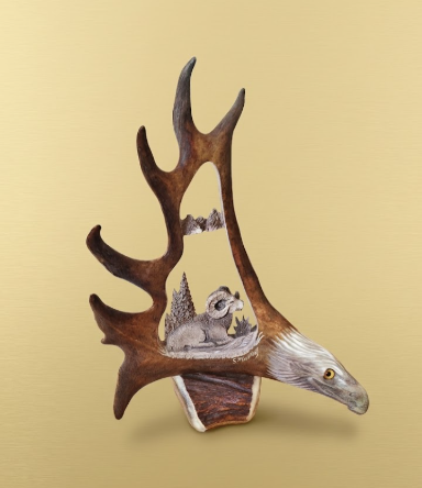 Decorative wall antler carving art with a eagles head and caribou antler on a beige background