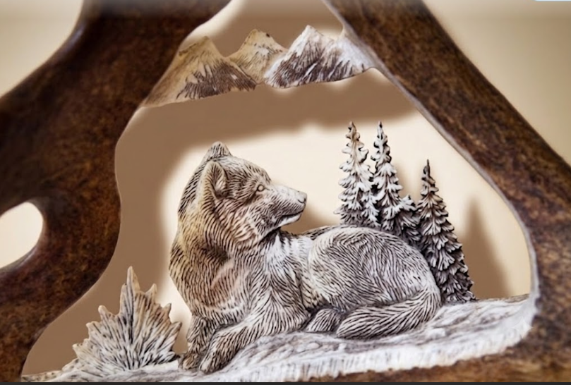 Wolf sculpture with a mountain and tree background