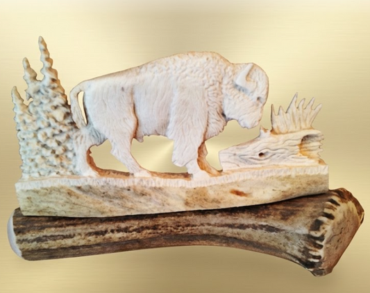 Bison antler carving on an antler with cream background
