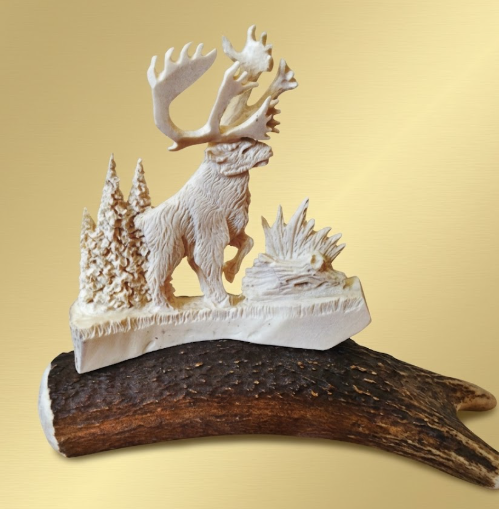 Decorative figurine of  a caribou made from antlers on a natural antler base against a beige background
