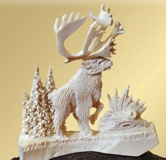 Carved caribou figure made from antlers on a yellow background